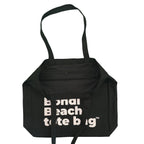Black tote bag with 'Beach tote bag' text on a white background