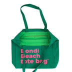 Green tote bag with pink text