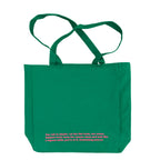 Green tote bag with pink text on a white background
