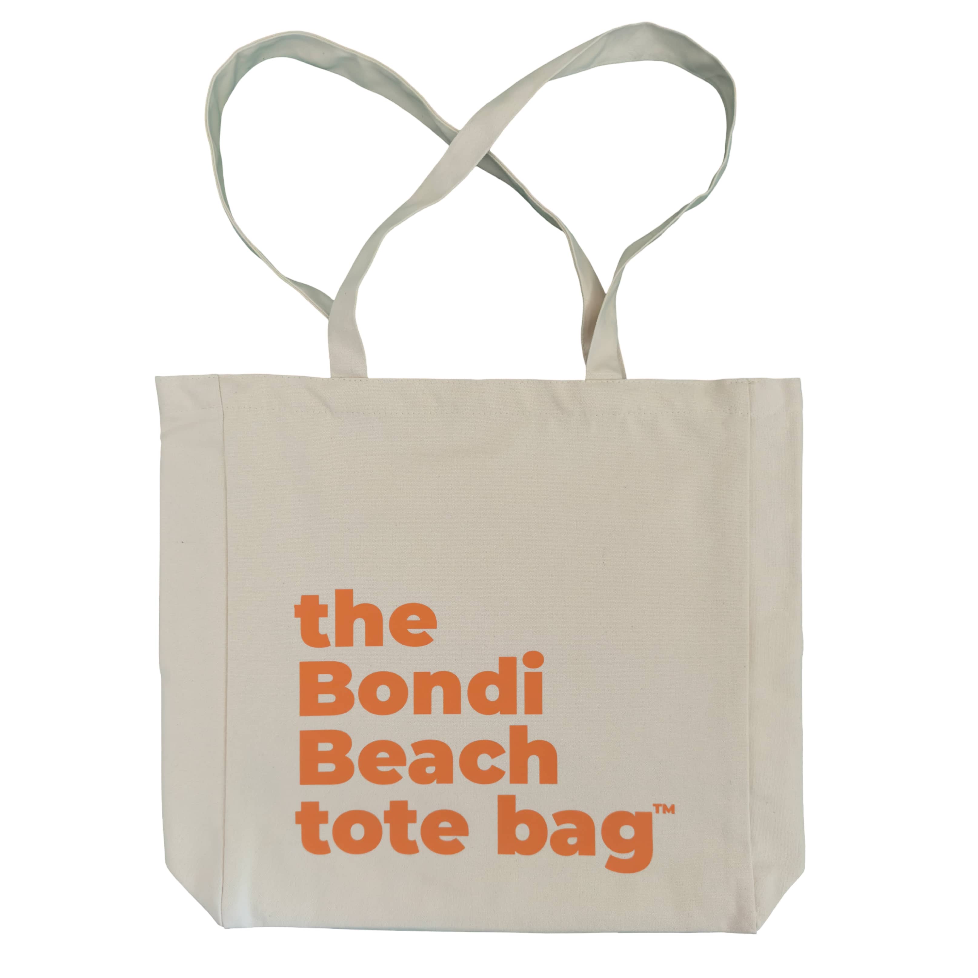 Beige tote bag with 'the Bondi Beach tote bag' text in orange on a white background
