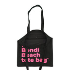 Black tote bag with pink text on a white background