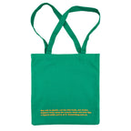 Green tote bag with peach orange text on a white background