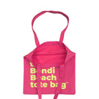 Pink tote bag with fluro green text
