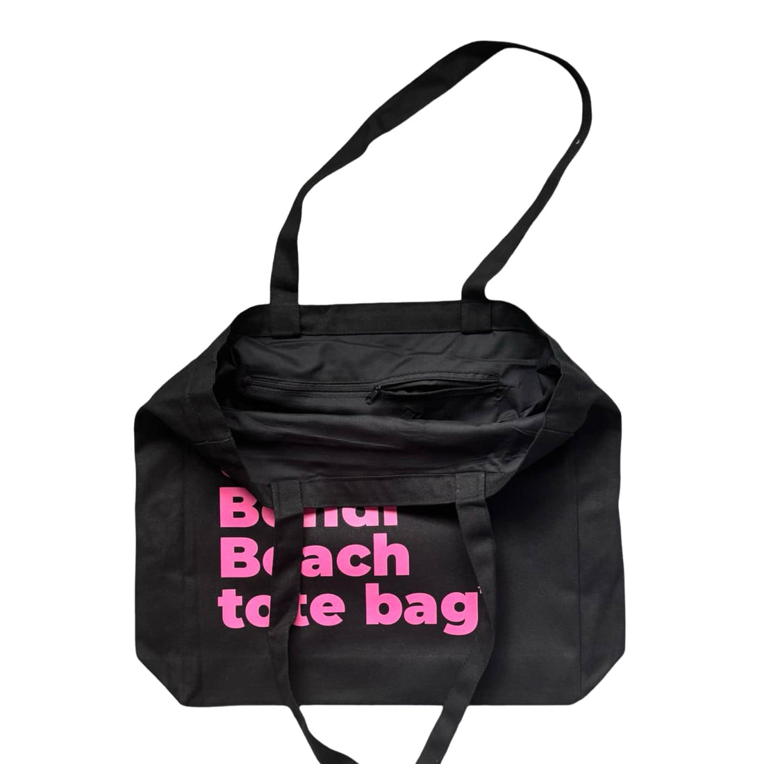The Bondi Beach tote bag Big Bondi in black with pink print open showing zip pocket and lining