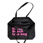 The Bondi Beach tote bag Big Bondi in black with pink print open showing zip pocket and lining