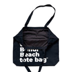 The Bondi Beach tote bag Big Bondi in black with white print open showing zip pocket and lining