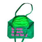 The Bondi Beach tote bag Big Bondi in green with fluro pink print open showing zip pocket and lining
