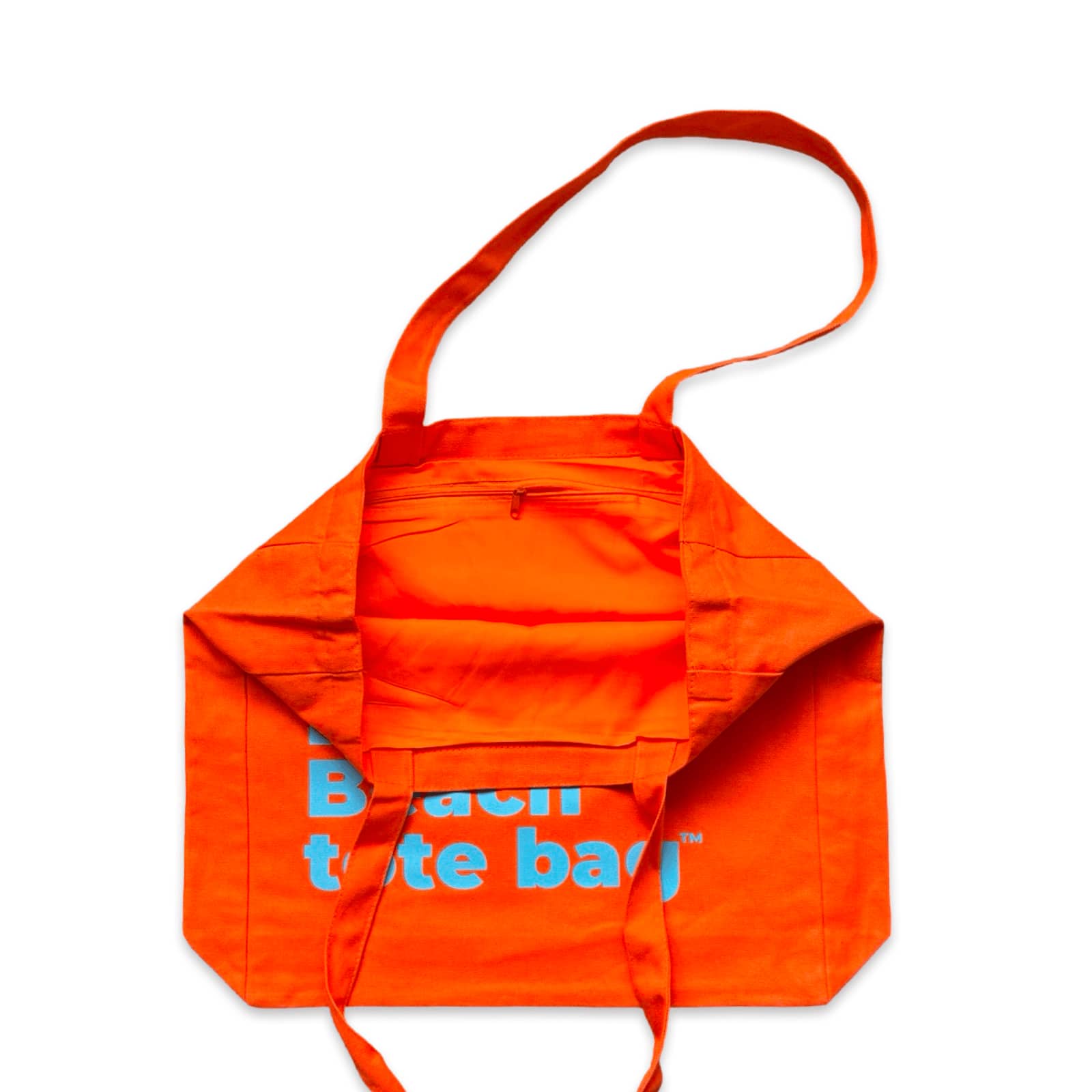 The Bondi Beach tote bag Big Bondi in orange with blue print open showing zip pocket and lining