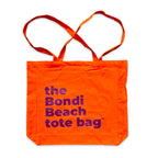 The Bondi Beach tote bag Big Bondi in orange with deep purple print flatlay closed showing structured canvas