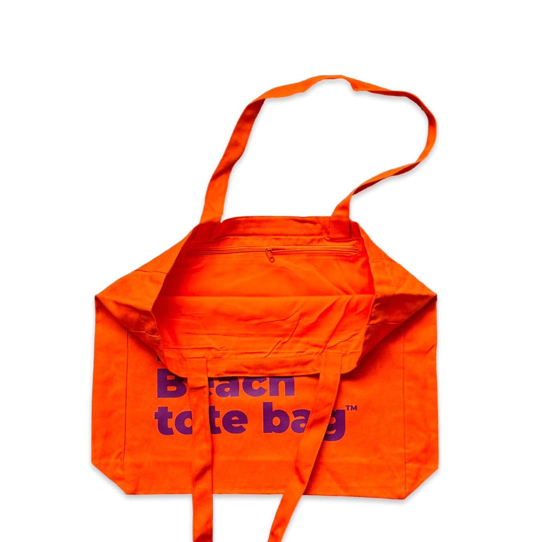 The Bondi Beach tote bag Big Bondi in orange with deep purple print open showing zip pocket and lining