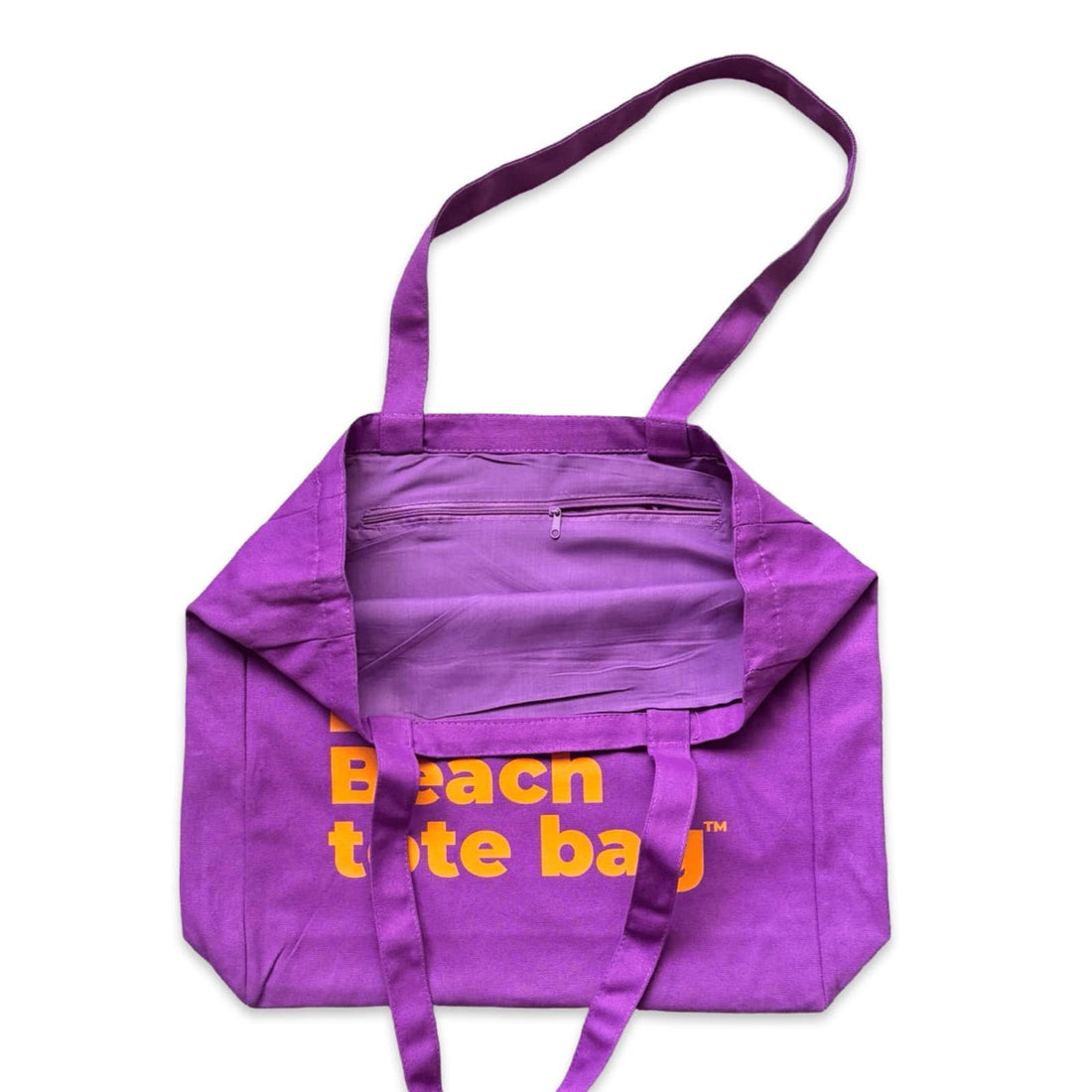 The Bondi Beach tote bag Big Bondi in purple with orange print open showing zip pocket and lining