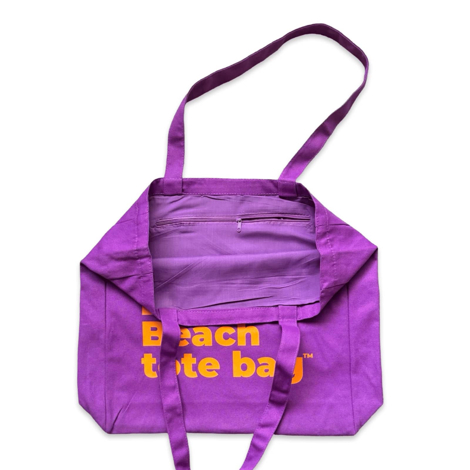 The Bondi Beach tote bag Big Bondi in purple with orange print open showing zip pocket and lining