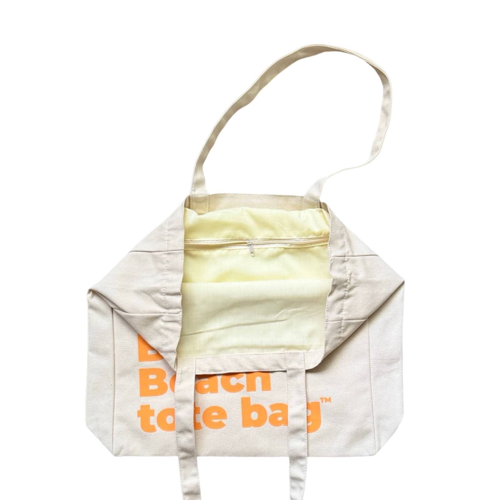 The Bondi Beach tote bag Big Bondi in off white with peach orange print open showing zip pocket and lining