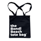The Bondi Beach tote bag Little Bondi in black with white print flatlay closed showing strong canvas structure