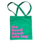The Bondi Beach tote bag Little Bondi in green with pink print flatlay closed showing slim durable canvas