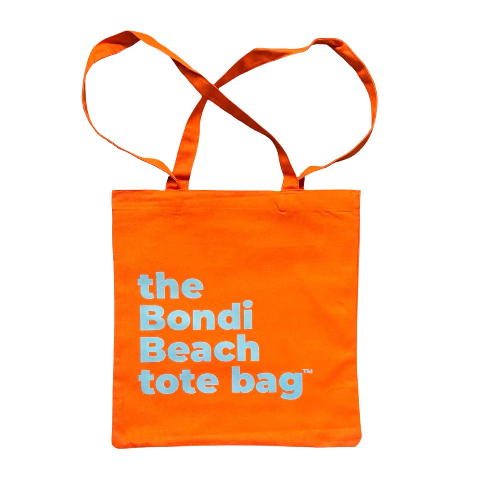The Bondi Beach tote bag Little Bondi in orange with blue print flatlay closed showing slim durable canvas