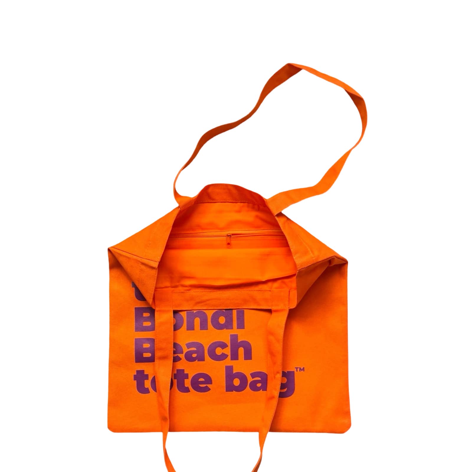 The Bondi Beach tote bag Little Bondi in orange with purple print open showing zip pocket and lining