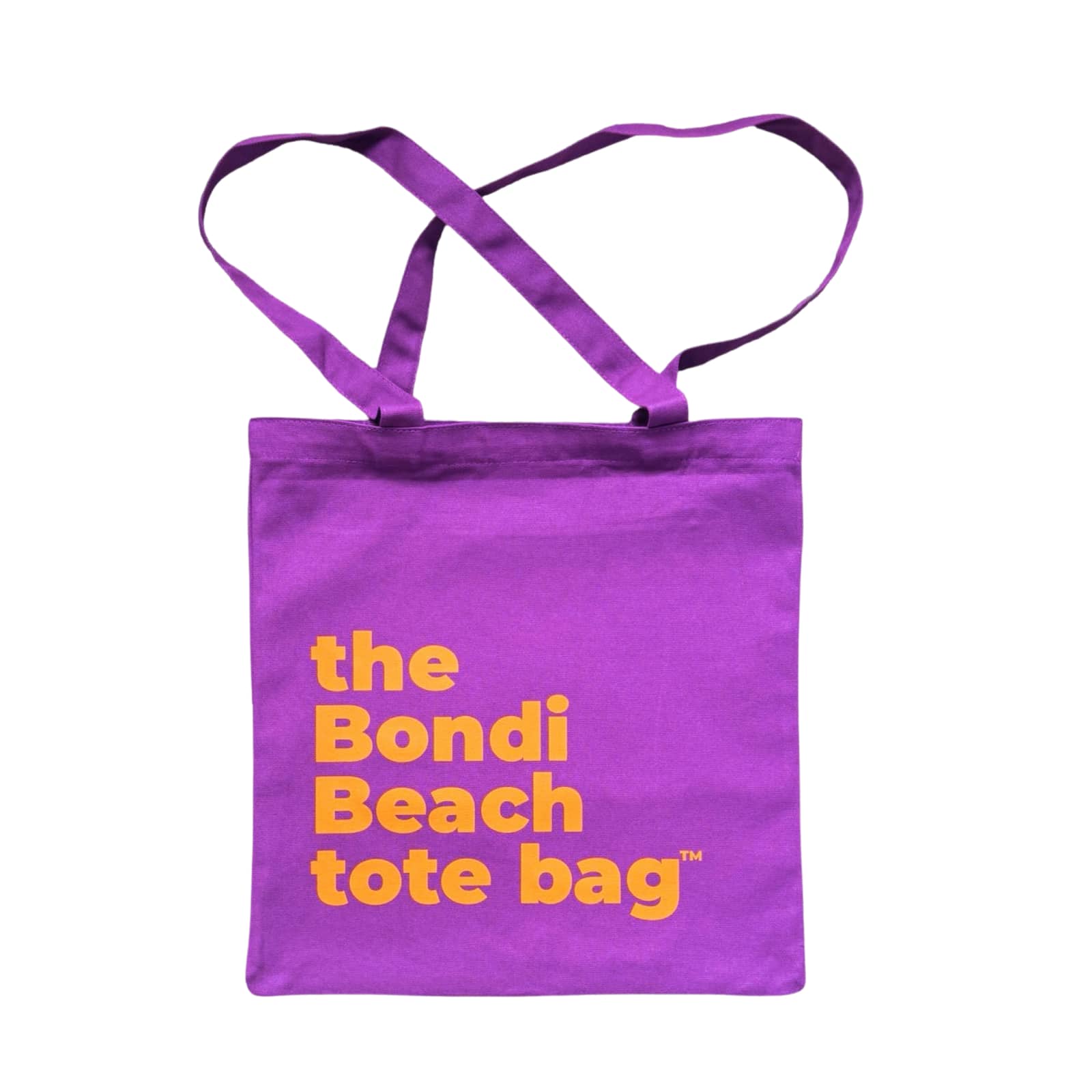 The Bondi Beach tote bag Little Bondi in purple with orange print flatlay closed showing slim durable canvas