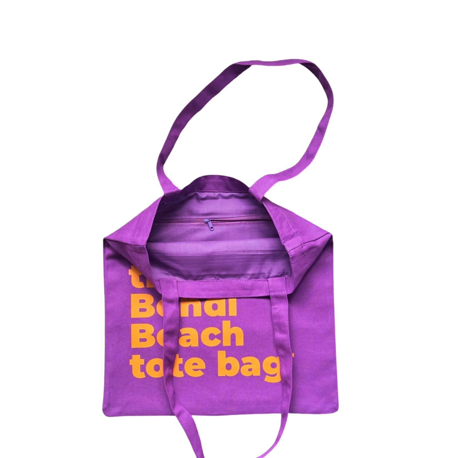 The Bondi Beach tote bag Little Bondi in purple with orange print open showing zip pocket and lining