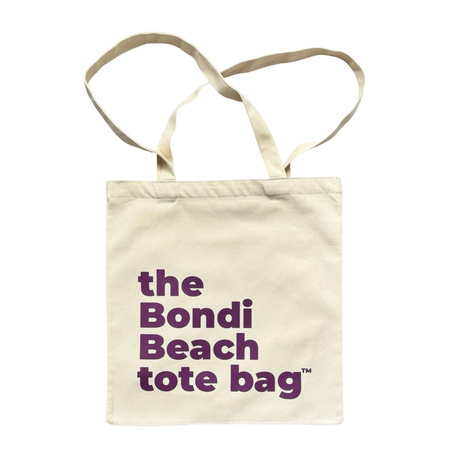 The Bondi Beach tote bag Little Bondi in white with purple print flatlay closed showing slim durable canvas