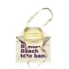 The Bondi Beach tote bag Little Bondi in white with purple print open showing zip pocket and lining