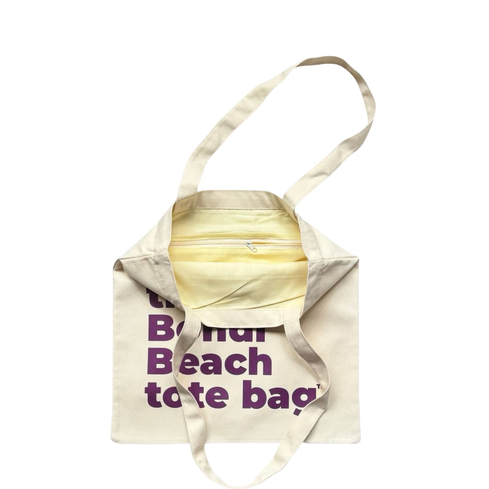 The Bondi Beach tote bag Little Bondi in white with purple print open showing zip pocket and lining